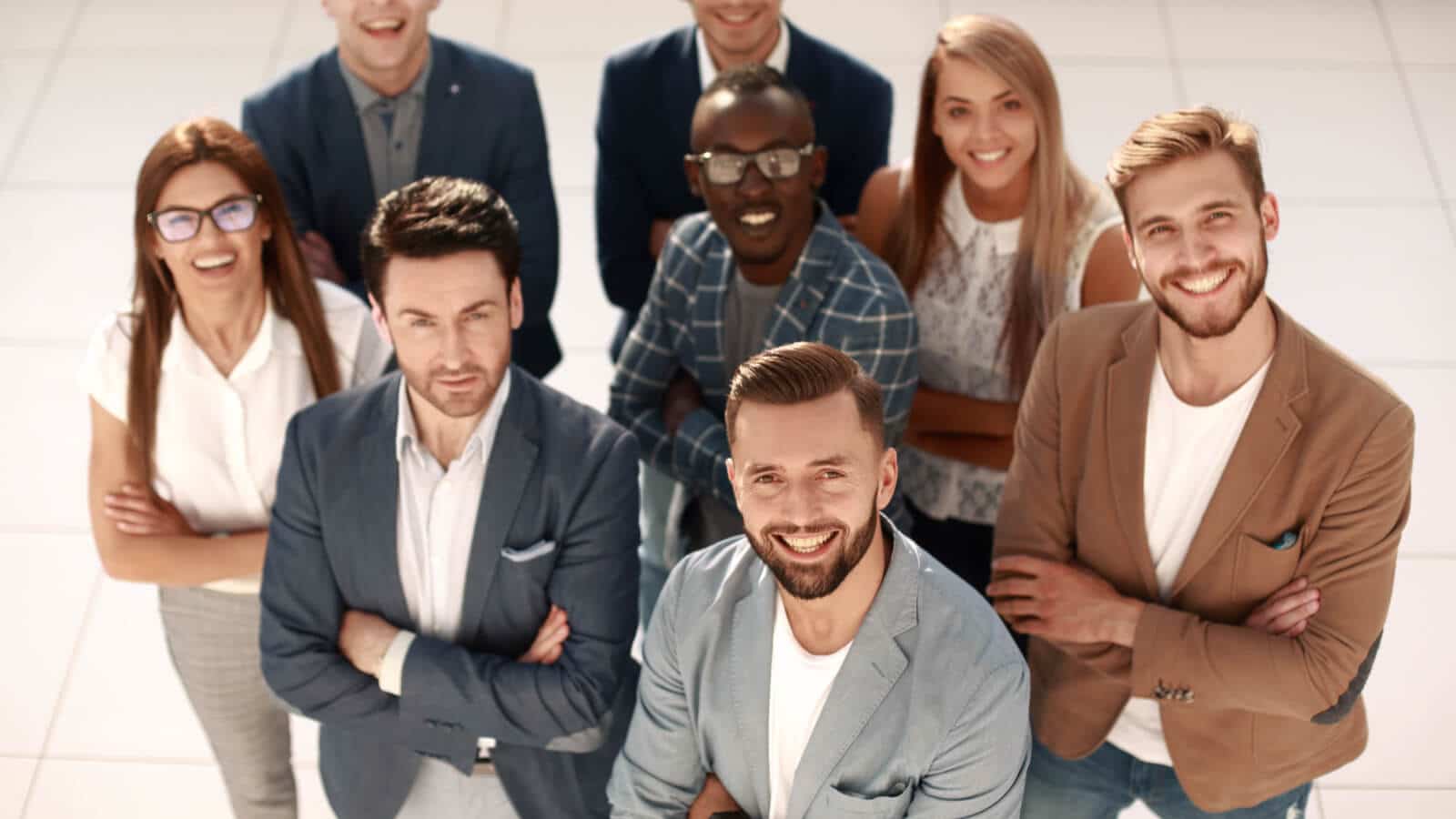 Ein Team, dass glücklich auf dem Gruppenfoto ist, da ihr Arbeitgeber Employer Branding betreibt